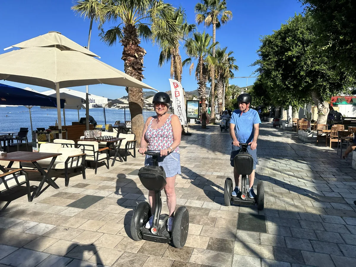Couple in front of a traditional blue-and-white Bodrum house